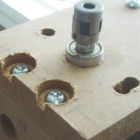 The z-axis coupling and bearing at the top of the z-axis assembly